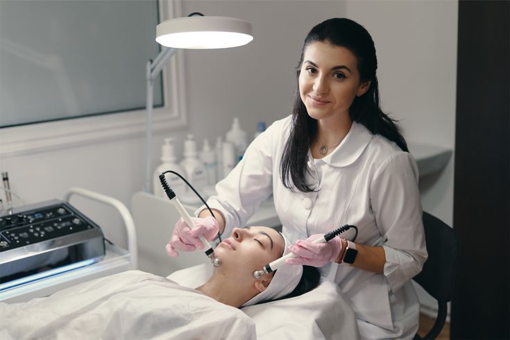 Student practicing laser treatments during a professional skin aesthetics training session