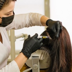 Doctor performing PRP therapy injections into the scalp for hair loss treatment and hair regrowth